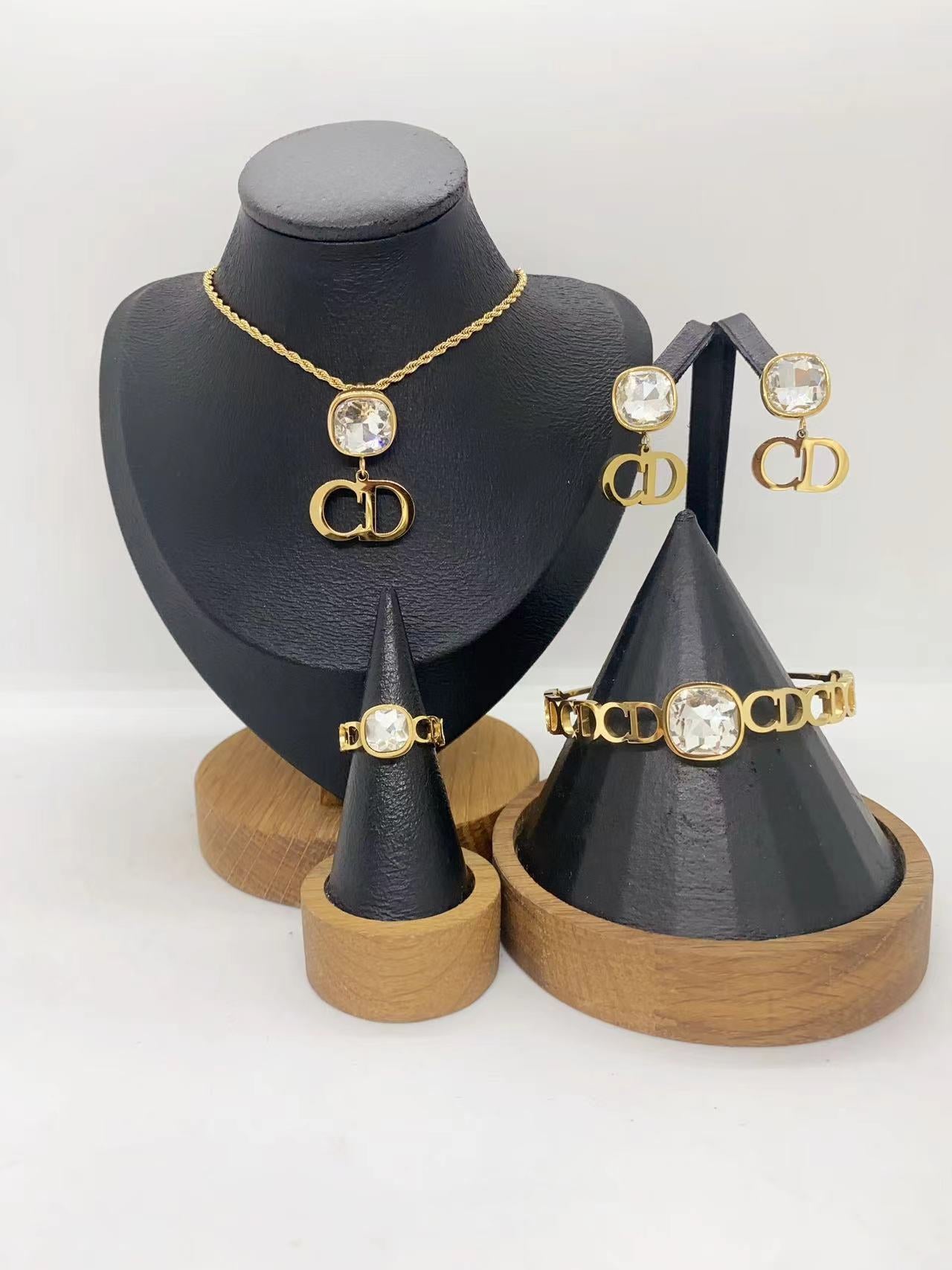 Elegant Gold Crystal Letter Charm Jewelry Set – Necklace, Earrings, Bracelet & Ring